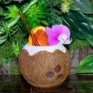 Secure the limited edition Kokomo Coconut Ceramic Tiki Mug now. Pre-order this tropical drink vessel, a coconut-shaped cup with straw, orange slice garnish, purple orchid, and lush green leaves. Ensure youre first in line once shipping begins!.